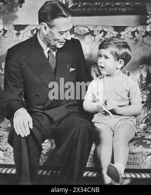 King George VI is captured sharing a moment with his grandson, Prince Charles, on Charles's third birthday on 14th November 1952. Shortly after this tender moment, King George VI passed away, leading to his daughter Elizabeth's ascension to the throne, where she reigned for 70 years. In 2022, Prince Charles inherited the title, becoming King Charles III. Stock Photo