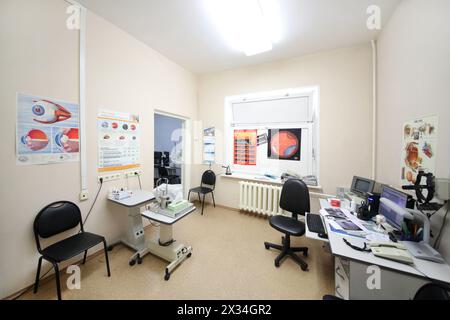RUSSIA, MOSCOW - AUG 31, 2015: office, workplace ophthalmologist with information posters on wall Stock Photo