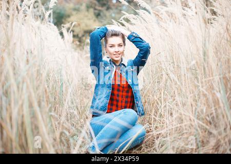 Young Beautiful Girl With A Smile In Denim Clothes. Stock Photo