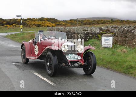 A 1936 Riley Kestrel leaves Caldbeck, Cumbria.  The car is taking part in the Flying Scotsman Rally, a free public-event. Stock Photo