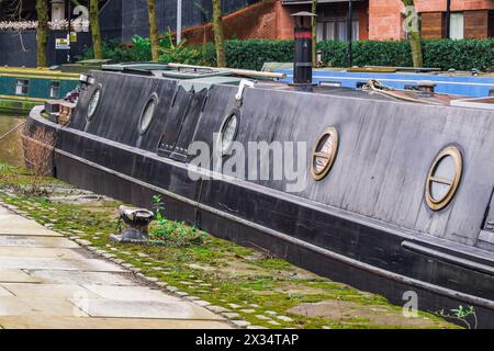 Castlefiled neighborhood canals with moored narrowboats on the waterfront in Manchester, UK. Stock Photo
