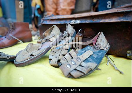 Handmade leather shoes exposed on table with various remittances Stock Photo