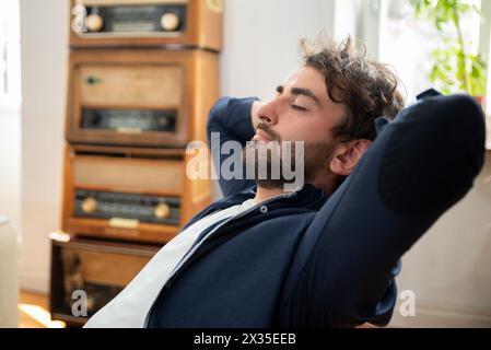 Young man enjoying relaxing day off at home. Man resting comfortable at home Stock Photo