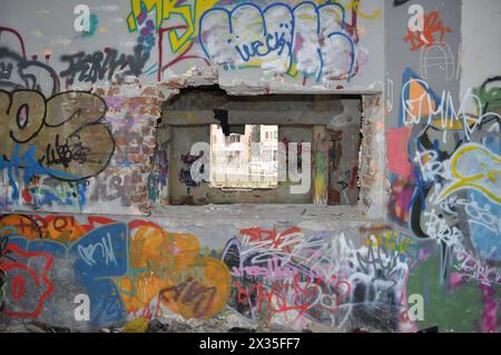 Big empty halls in old abandoned factory building. Soap factory in Skopje. Covered with graffiti by unknown artists. The building no longer exists. Stock Photo