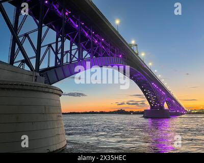 The International Peace Bridge connecting the United States and Canada, between Buffalo, New York and Fort Erie, Ontario, was illuminated in purple light on April 15, 2024 to highlight Month of the Military Child. Purple references the joint environment of the military, encompassing all service branches, Active Duty, Reserve, National Guard, and Veterans. Purple combines each branch's colors into one. (U.S. Air Force photo by Senior Master Sgt. Andrew Caya) Stock Photo