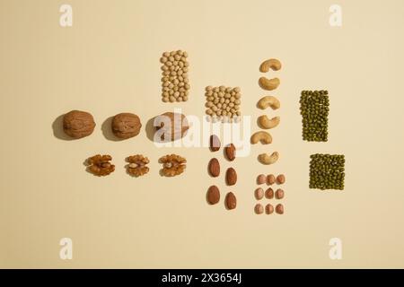 View from above of different types of beans and nuts against the beige background. Beans contain several vital nutrients good for health Stock Photo