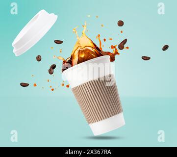 Aromatic coffee in takeaway paper cup and roasted beans in air on turquoise background Stock Photo