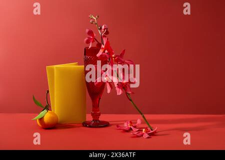 Front view of yellow envelopes decorated with a branch of pink flowers and a glass. Chinese people consider traditional New Year to be the biggest hol Stock Photo