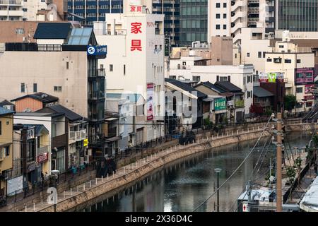 Fukuoka, Japan - May 14 2023: Sunset over traditional houses and buildings along the Hakata river old town area in Fukuoka in Kyushu largest city in J Stock Photo