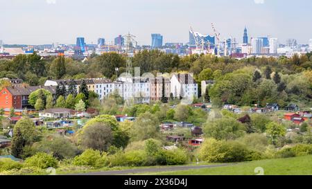 Hamburg, Germany. 23rd Apr, 2024. View from Georgswerder energy hill over allotments towards Hafencity and the Elbphilharmonie concert hall. Credit: Markus Scholz/dpa/Alamy Live News Stock Photo