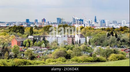 Hamburg, Germany. 23rd Apr, 2024. View from Georgswerder energy hill over allotments towards Hafencity and the Elbphilharmonie concert hall. Credit: Markus Scholz/dpa/Alamy Live News Stock Photo