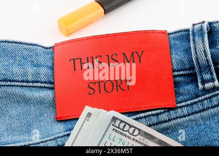 Business and my story concept. Text This is my story on the leather insert of jeans with dollar bills sticking out Stock Photo