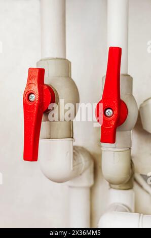 Ball valve used to control flow of water on a pvc pipe that serves as a gateway with Close up of its handle Stock Photo