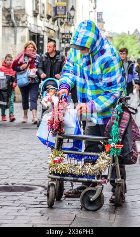 Old man with tinsel decorated mobile walking aid - Tours, Indre-et-Loire (37), France. Stock Photo