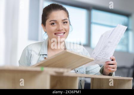 happy woman assembling a furniture Stock Photo