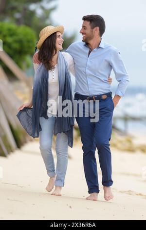 couple walking along the sea shore Stock Photo