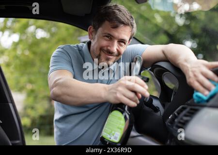 young man polishing vehicle interior Stock Photo