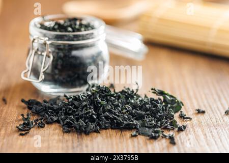 Dried wakame seaweed on a wooden table. Stock Photo