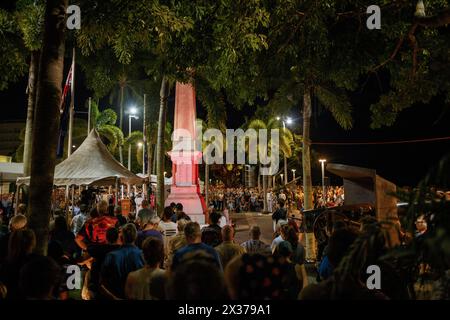 People stand at the Cairns Cenotaph during the ANZAC Day dawn service. Current and retired Australian Defence Force members and their families took part in the ANZAC Day dawn service at the Cairns Cenotaph and march along Cairns Esplanade organized by the Cairns RSL (Returned and Services League of Australia) on the 25th of April 2024.Though ANZAC Day was initially to commemorate those lost during the Gallipoli campaign during the First World War, it is now marked in remembrance of all service people killed in military actions. Stock Photo