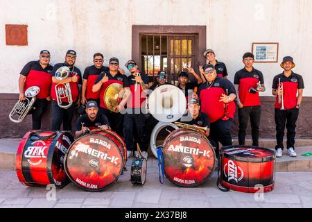 Musicians Rest In The Shade Before Performing In La Fiesta de la Virgen de la Candelaria, San Pedro de Atacama, Antofagasta Region, Chile. Stock Photo