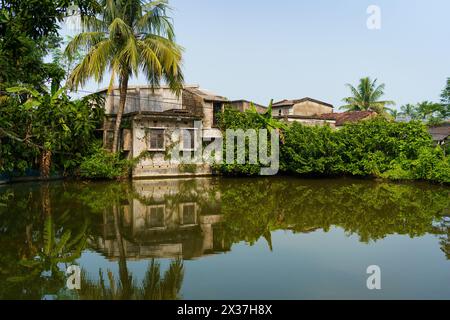 Traditional indian house and lakes and puddle seen in the indian Sundarbans, the largest mangroves forest in the world. Pristine rural habitat in the Stock Photo