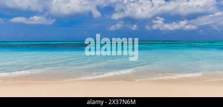 Closeup of sand on beach and blue summer sky. Panoramic beach landscape. Empty tropical beach and seascape. Orange and golden sunset sky, soft sand Stock Photo
