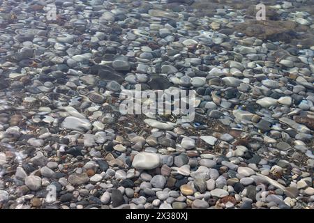 Submerged Pebbles in Clear Water Stock Photo
