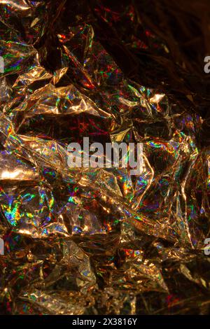 A Holographic Crumpled Gold Bronze Paper Material which is Shiny for Background Stock Photo