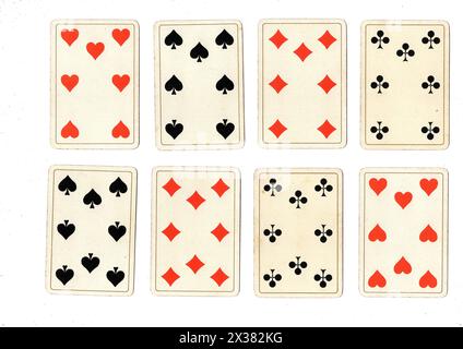 Antique playing cards showing sevens and eights in all suits isolated on a white background. Stock Photo