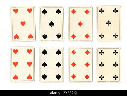 Antique playing cards showing fives and sixes in all suits isolated on a white background. Stock Photo