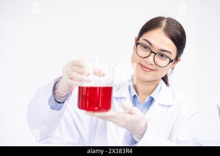 The female scientist is conducting an experiment in the laboratory Stock Photo