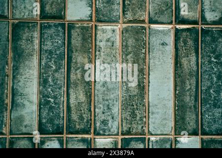 A pattern of modern vertical rectangular malachite tiles. Realistic texture. The walls are lined with green ceramic tiles with space for copying. High quality photo Stock Photo