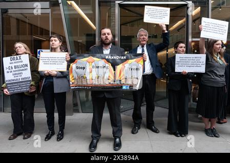 London, UK. 25 April, 2024. Climate activists protest the Drax Group PLC annual general meeting over the environmental and human impacts of its operations. The former Drax coal power station, which receives large public subsidies, burns imported wood pellets, including from trees felled in primary forests, and is one of the single largest emitters of CO2 and particulate matter (PM10) in the UK. Critics also contest its claim to be a renewable energy source. Credit: Ron Fassbender/Alamy Live News Stock Photo