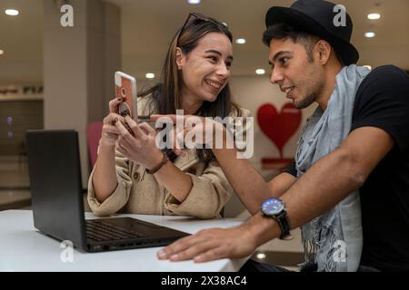 Young latin couple plan their Valentine's Day trip. Concept online shopping, Valentine's Day Stock Photo