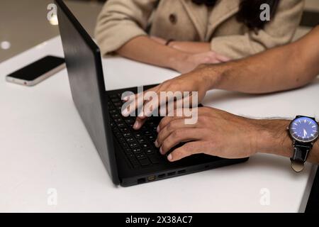 Unrecognizable couple. Man hands typing on a laptop. Stock Photo