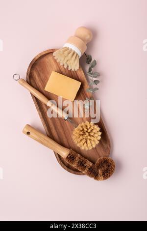 Set of wooden bamboo brushes for washing dishes and cleaning home, flat lay. Zero waste eco friendly cleaning concept. Stock Photo