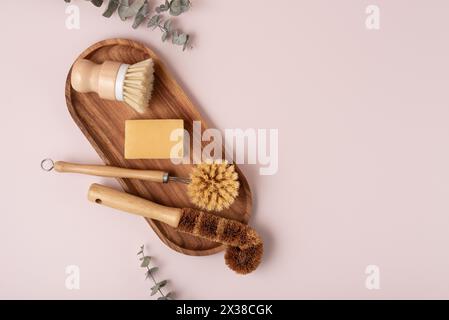 Set of wooden bamboo brushes for washing dishes and cleaning home, flat lay. Zero waste eco friendly cleaning concept. Stock Photo