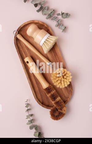 Set of wooden bamboo brushes for washing dishes and cleaning home, flat lay. Zero waste eco friendly cleaning concept. Stock Photo