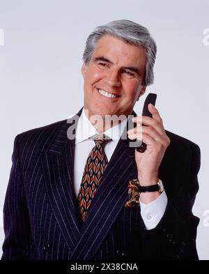 Business & Professions. Older man using mobile phone. Stock Photo