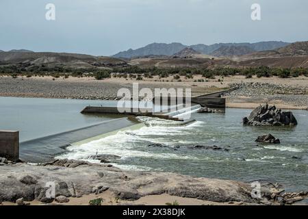 A weir controlling the flow of water in the orange river in Namibia. Stock Photo