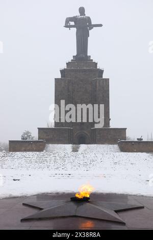 YEREVAN, ARMENIA - JAN 05, 2017: Eternal fire and Mother Armenia monument among at winter overcast day Stock Photo
