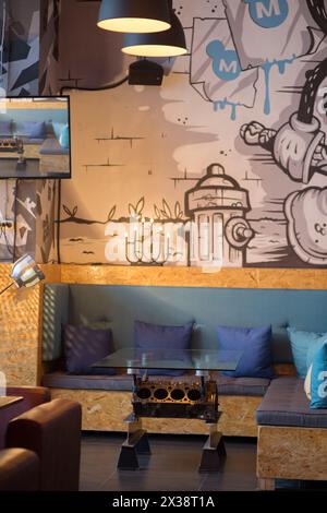 MOSCOW - JAN 23, 2017: Industrial table in restaurant Illskill modern interior, New Illskill complex includes car service, hookah, restaurant, barbers Stock Photo