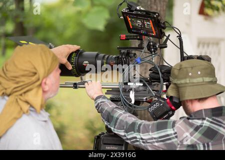 RUSSIA, MOSCOW – 30 JUL, 2015: Men are shooting movie (Maximum shock) with professional digital video camera in the Sokolniki park. Stock Photo