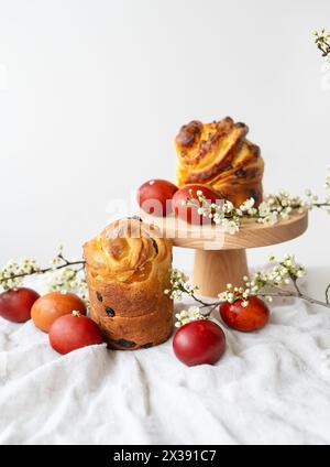 Festive table setting, Easter pastries on a wooden stand and cherry blossoms. Easter holiday concept Stock Photo