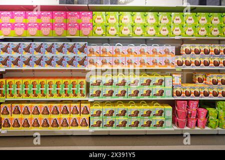 M&S Easter Egg shelving stocked with Chocolate confectionary in colourful packaging illustrating novelty fun characters aimed at children England UK Stock Photo