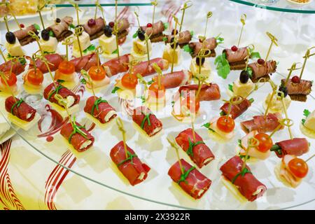 Many canapes - cold appetizers are on table with white cloth Stock Photo