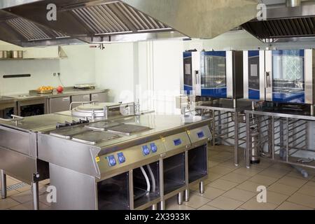 Kitchen room with stoves, sinks and refrigerators in restaurant. Stock Photo