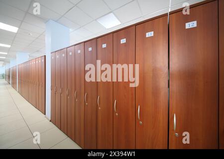 Long hallway with many wooden cabinets in big office of company Stock Photo