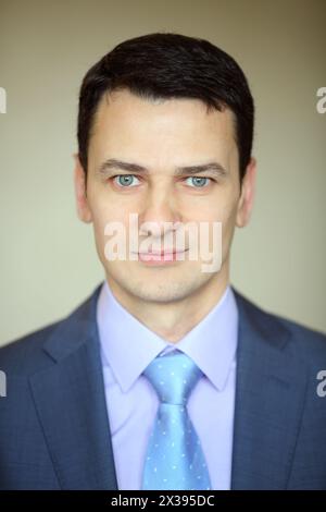 Smiling elegance brunet man in business suit with tie in studio Stock Photo