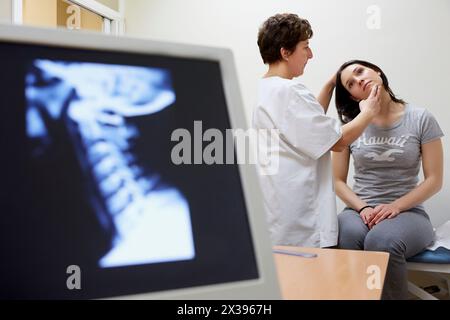 Doctor checking neck tilt, Cervical X-ray image, Physiotherapy medical center, Donostia, San Sebastian, Gipuzkoa, Basque Country, Spain Stock Photo